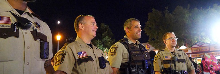 Four uniformed deputies at the Minnesota State Fair at night.